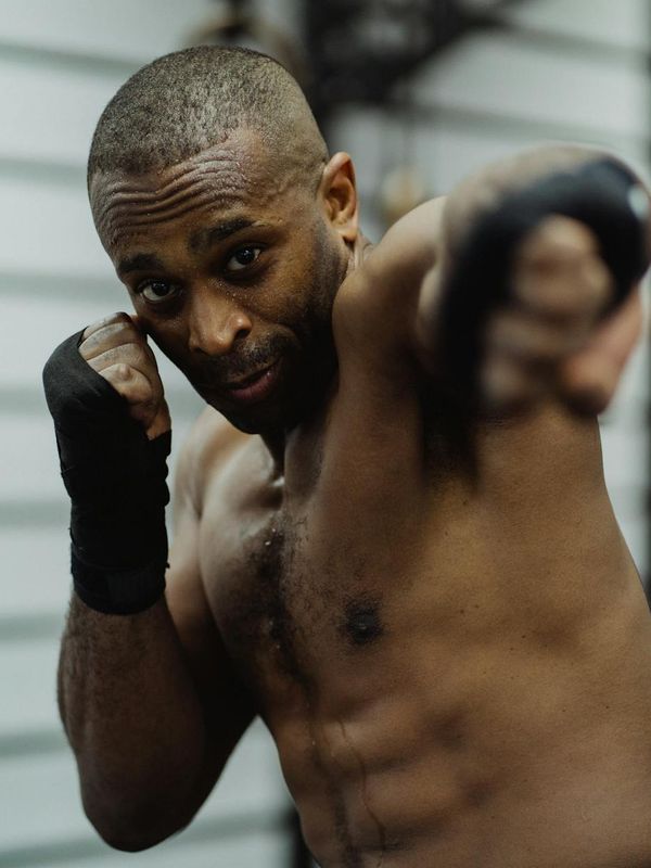 Man in a focused stance, preparing for a strength exercise.